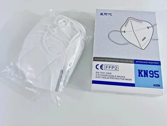 A white box of KN95 masks with "CE FFP2" and "10 pcs" visible, next to a clear plastic bag containing several white KN95 masks.